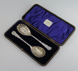 A pair of Victorian silver sifter spoons with floral and scroll decoration Sheffield 1898, 86 grams, cased 