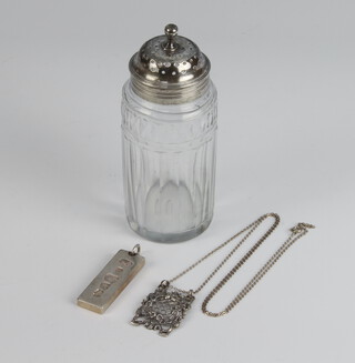 A Georgian silver mounted cut glass shaker 12cm, an ingot and white metal House of Commons style pendant 