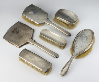 An Art Deco silver dressing table set comprising hand mirror, hair brush, clothes brush Birmingham 1934 together with a hair brush and clothes brush