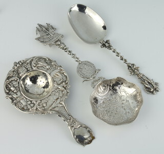 A Continental pierced repousse silver strainer together a sifter spoon and serving spoon, 202 grams