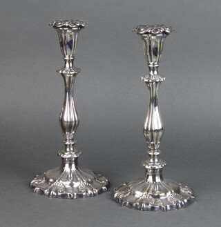 A pair of silver plated Georgian design candlesticks with shell motifs and tapered stems 28cm 