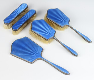 An Art Deco silver and blue guilloche enamel dressing table set comprising 2 hairbrushes, 2 clothes brushes and a hand mirror Birmingham 1930 