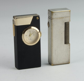 A gentleman's silver plated engine turned Dunhill cigarette lighter together with a Rivo cigarette lighter watch 