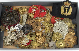 A collection of Second World War and other Army cap badges etc 