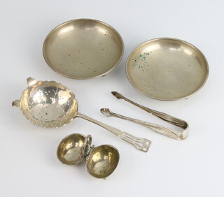 A silver tea strainer 1942, 2 white metal bowls, a salt and a pair of tongs 