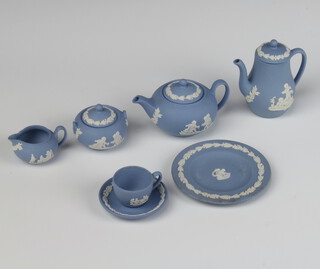 A Wedgwood blue Jasperware miniature teaset comprising teapot, milk jug, sugar bowl, coffee pot, tea cup, saucer and plate 
