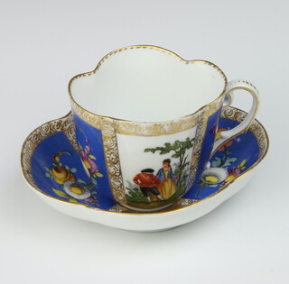 A Meissen cabinet cup and saucer decorated with fete gallant and floral panels 