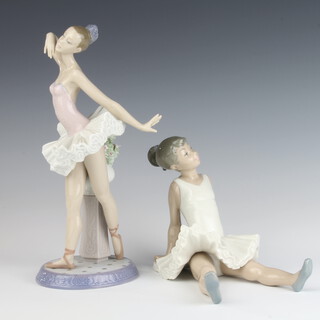 A  Lladro ballerina standing beside an urn of flowers 6323 26cm together with a Nao figure of a seated ballerina 15cm 