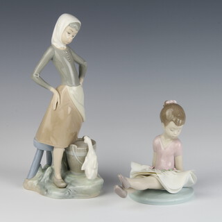A Lladro figure of a goose girl 23cm and a ditto of a seated ballerina 6690 12cm 