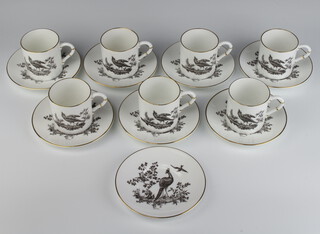 A set of 7 Royal Worcester coffee cans and 8 saucers decorated with exotic birds 