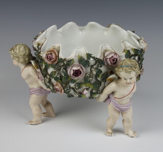 A 19th Century German bowl supported by 3 cherubs encrusted with flowers 16cm 