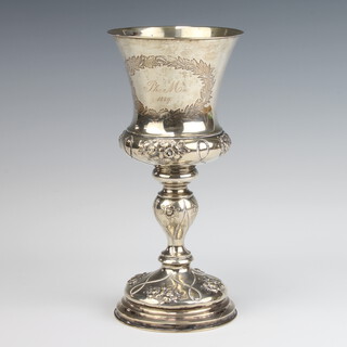 A Continental repousse white metal goblet decorated with flowers, weighted base, 20cm 