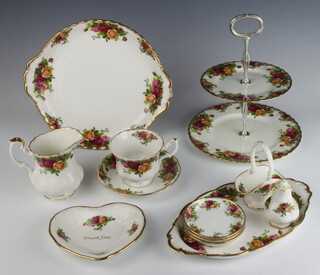 A Royal Albert Old Country Roses pattern part tea set comprising 1 large plate, 1 two tier cake stand, 1 oval dish, 7 tea cups, 17 saucers, 3 coffee cups, teapot stand, milk jug, 4 plates, 3 dishes, pepper pot, 11 tea plates and 3 dinner plates 