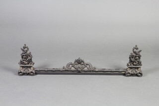 A 19th Century Continental pierced iron fender decorated birds and swags 28cm h x 101cm w x 9cm d 