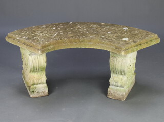 A well weathered reconstituted stone crescent shaped garden bench raised on scole supports 45cm h x 108cm w x 36cm d 