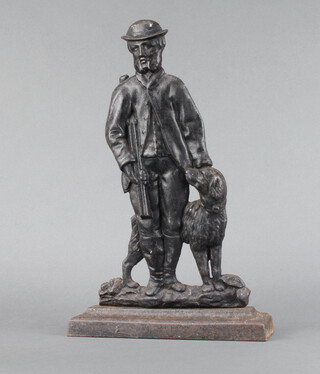 A Victorian cast iron doorstop in the form of a standing game keeper with dog 39cm h x 25cm w x 7cm 