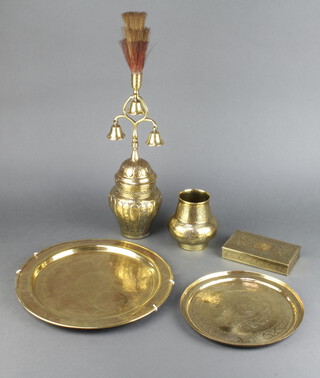 An Eastern pierced and embossed brass urn and cover surmounted by 3 bells 50cm h, 2 circular benares brass trays 30cm and 23cm, ditto vase 12cm and a similar box 3cm h x 15cm w  9cm d  