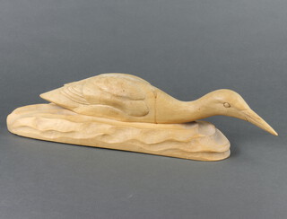 W Lang, a carved wooden figure of a duck in water, base marked W Lang April 2nd 1962 10cm x 49cm x 4cm 