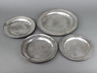 A 17th/18th Century circular polished pewter plate the reverse with touch marks 30cm diam. (some contact marks) together with 3 others (2 unmarked) 24cm and 22cm and 1 marked IC 23cm 