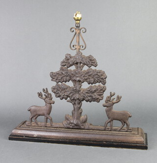 A Victorian door stop in the form of a tree and 2 standing stags, converted to a table lamp, raised on a wooden base 45cm h x 47cm w x 11cm d 