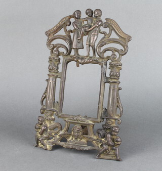A Victorian cast metal easel photograph frame surmounted by a figure group of a family with 2 columns to the side, the reverse marked RD618053 34cm h x 22cm w 