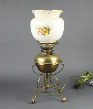 A brass oil lamp raised on a shaped base converted to an electric table lamp with opaque glass chimney 37cm h x 20cm 