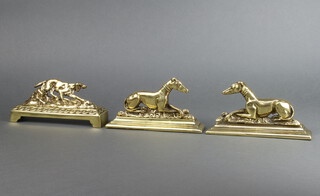 A pair of pierced brass table ornaments in the form of  greyhounds 8cm x 12cm x 4cm together with 1 other in the form of a setter 7cm x 19cm x 4.5cm 