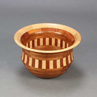A circular turned wooden parquetry bowl with panelled decoration 22cm h x 37cm diam. 