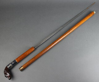 A 19th Century sword stick with 65cm blade contained in a malacca cane with dogs head handle marked J Pollard 