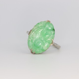 A 9ct white gold Art Deco carved green hardstone dress ring, size L, 2.7 grams