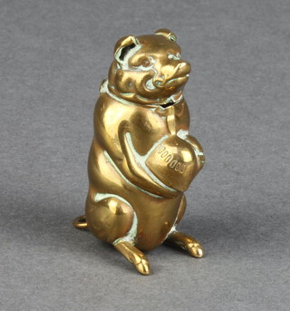 An Edwardian brass vesta case in the form of a seated dog clasping an apple 4cm x 2cm x 2cm 