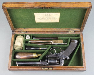 A five shot, 54 bore improved frame single action Adams percussion revolver with octagonal barrel fitted with a Rigby patent ramer, the cylinder with London proof mark and serial no.14312, the top marked Deane.Adams & Deane 30 King William Street London Bridge, the butt fitted a cap box, together with a brass bullet mould, turn key, copper and brass powder flask by James Dixon, steel oiler, all contained in an oak case the interior labelled Deane and Sons  