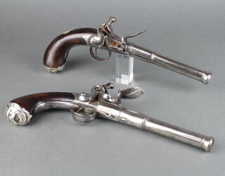 Hawkins, a pair of 18th Century cannon barrel English belt pistols with 14cm screw off barrels, marked London, the breech marked Hawkins London and with walnut grips, silver butt caps decorated grotesques and inlaid silver trophies to the side  