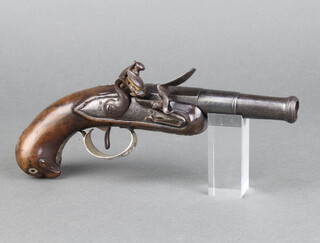 An 18th Century flintlock pocket pistol with 7cm turn off cannon barrel, having a "silver" trigger guard decorated trophies, the carved walnut butt decorated an owl with inlaid mother of pearl eyes, 20cm overall  
