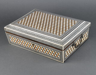 A Moorish carved inlaid ivory sewing box with hinged lid, the interior with tray and lidded compartments 9cm h x 32cm w x 24cm d 