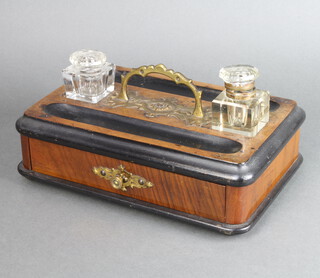 A Victorian walnut and ebonised standish with 2 associated cut glass bottles (chipped) and pen recess, the base fitted a drawer, raised on bun feet 10cm h x 30cm w x 19cm d 