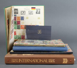 A Victorian penny black, a Stanley Gibbons International stamp album of used World stamps - Poland, Kenya, Hungary, Germany, Czechoslovakia, a Universal album of world stamps Romania, German, Indonesia and 4 other albums of used world stamps 