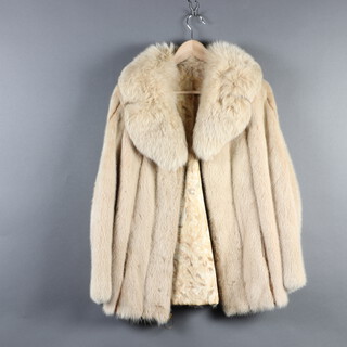 A lady's 1/2 length blonde mink coat with zip front  