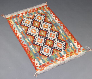 A black, brown and green ground Chobi Kilim rug with 2 rows of 8 diamonds to the centre 134cm x 81cm 