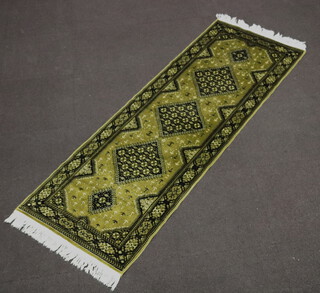 A green and black ground Belgian cotton runner with 5 diamonds to the centre 209cm x 72cm 