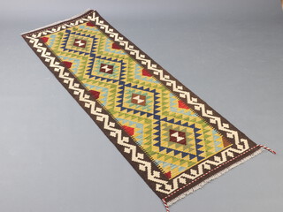 A green, blue and brown ground Maimana Kilim runner with all over geometric design and 4 diamonds to the centre   197cm x 70cm 