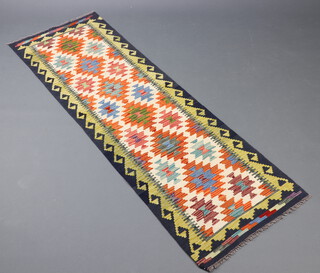 A white, orange and green ground Chobi Kilim runner with 7 stylised medallions to the centre within 2 rows of medallions 198cm x 64cm 