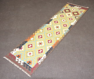 A tan, black and green ground Maimana Kilim runner with all over geometric design 293cm x 81cm 