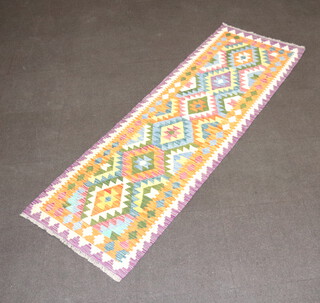 A tan, turquoise, green and purple ground Chobi Kilim runner with 6 diamonds to the centre 240cm x 79cm 