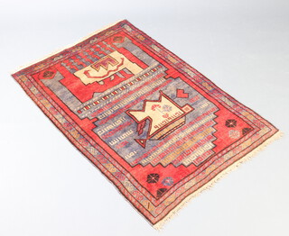 A cream, red and blue ground Belouche rug with serpent design to the centre within a 3 row border 135cm x 93cm 
