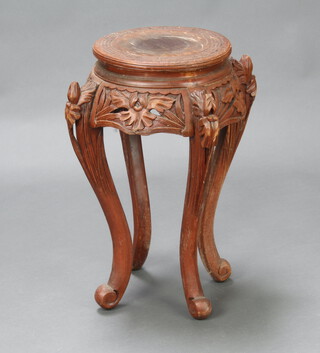 A circular Chinese carved and pierced hardwood jardiniere stand, raised on cabriole supports 61cm h x 30cm diam. 