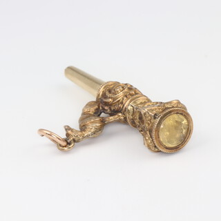 A 19th Century gilt watch key with dog finial and hardstone end (chipped) 4cm