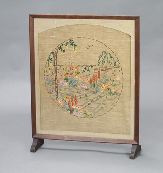 A 1930's oak fire screen with floral embroidered panel to the centre 67cm x 53cm x 13cm d 