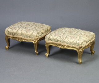 A pair of Louis style gilt painted footstools of serpentine outline, raised on cabriole supports 19cm h x 40cm w x 31cm d 