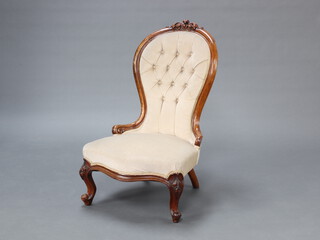 A Victorian carved walnut show frame nursing chair upholstered in buttoned dralon, raised on cabriole supports 95cm h x 58cm w x 50cm d (seat 36cm x 33cm) 